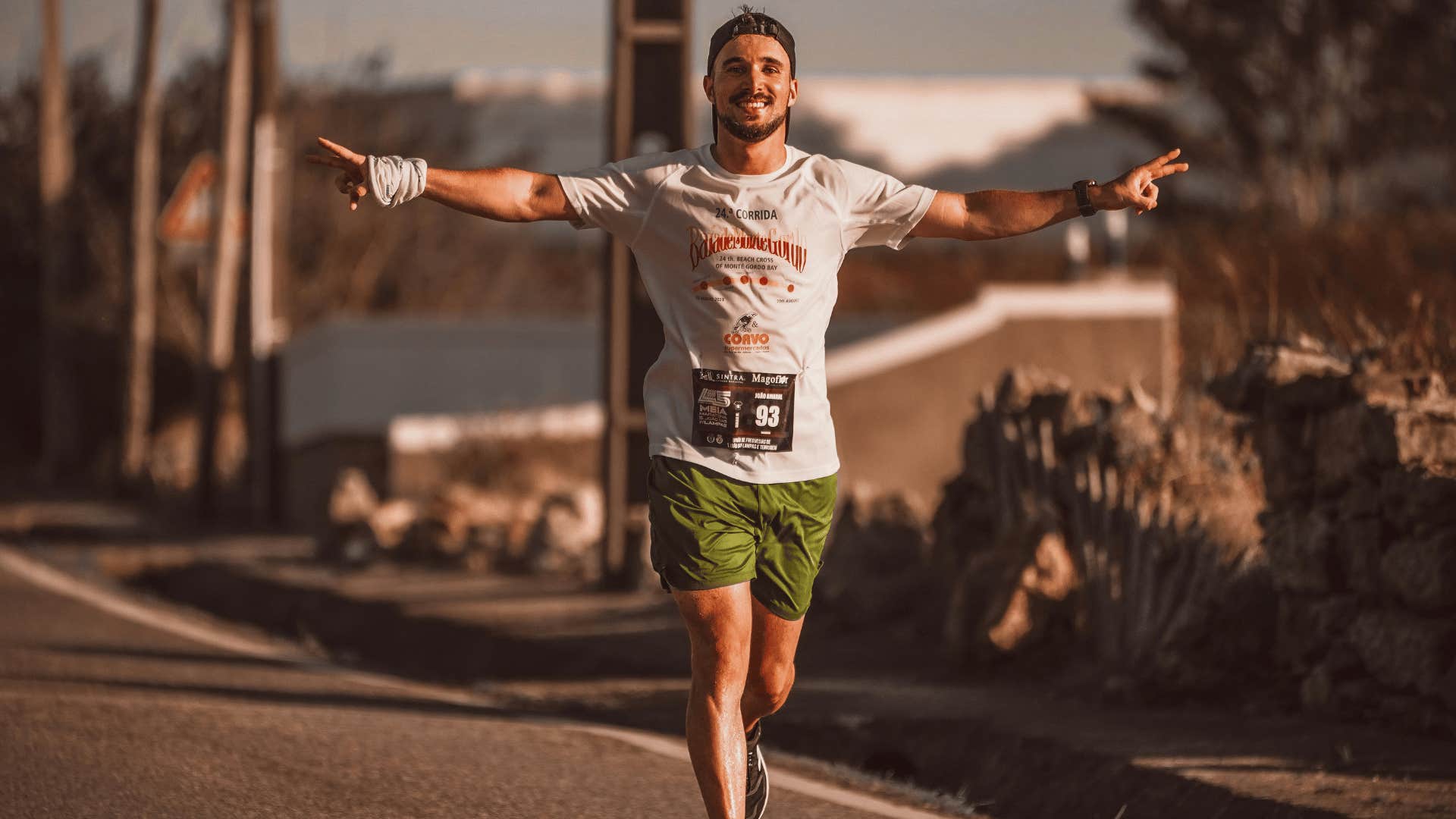 smiling man running a marathon