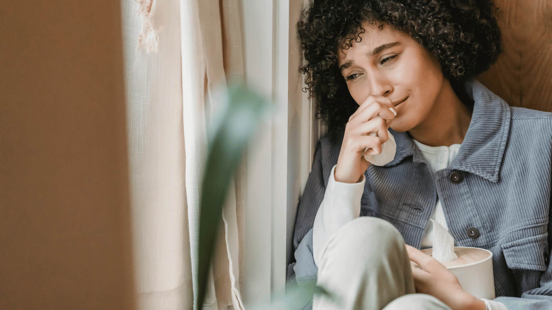 woman crying near window