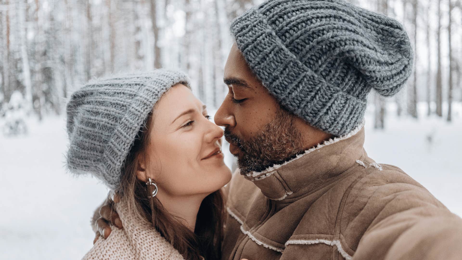 couple standing close in winter clothes