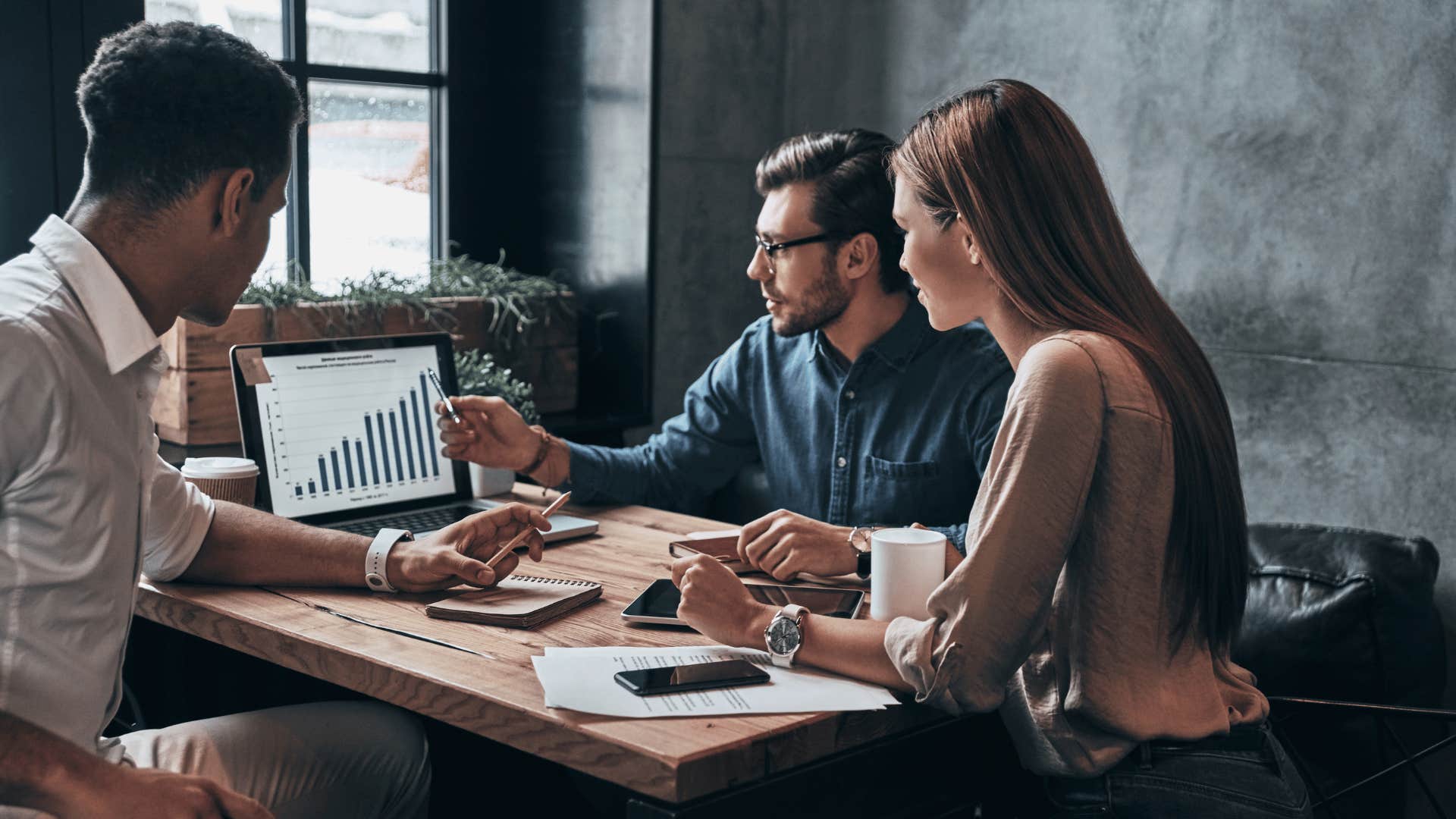 three employees in a meeting