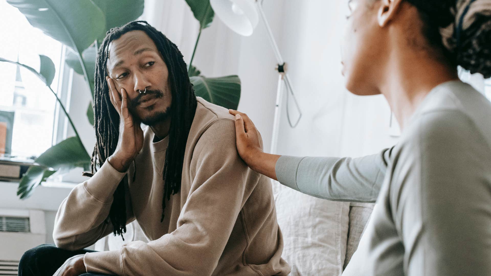 woman comforting somber man