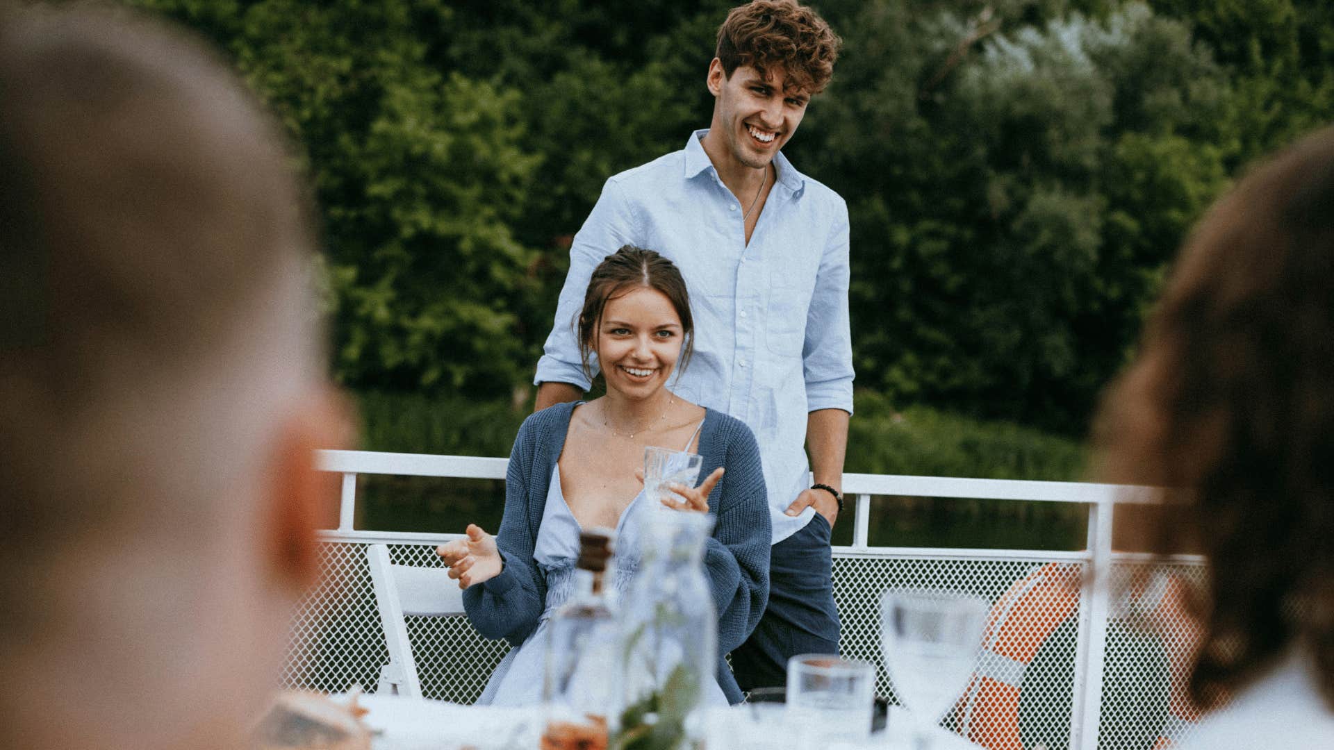 smiling couple facing blurred couple