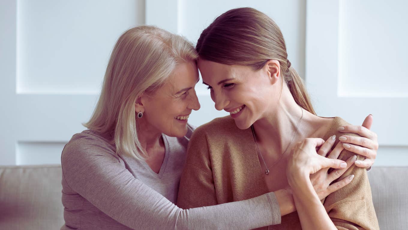 adult daughter and mom hugging