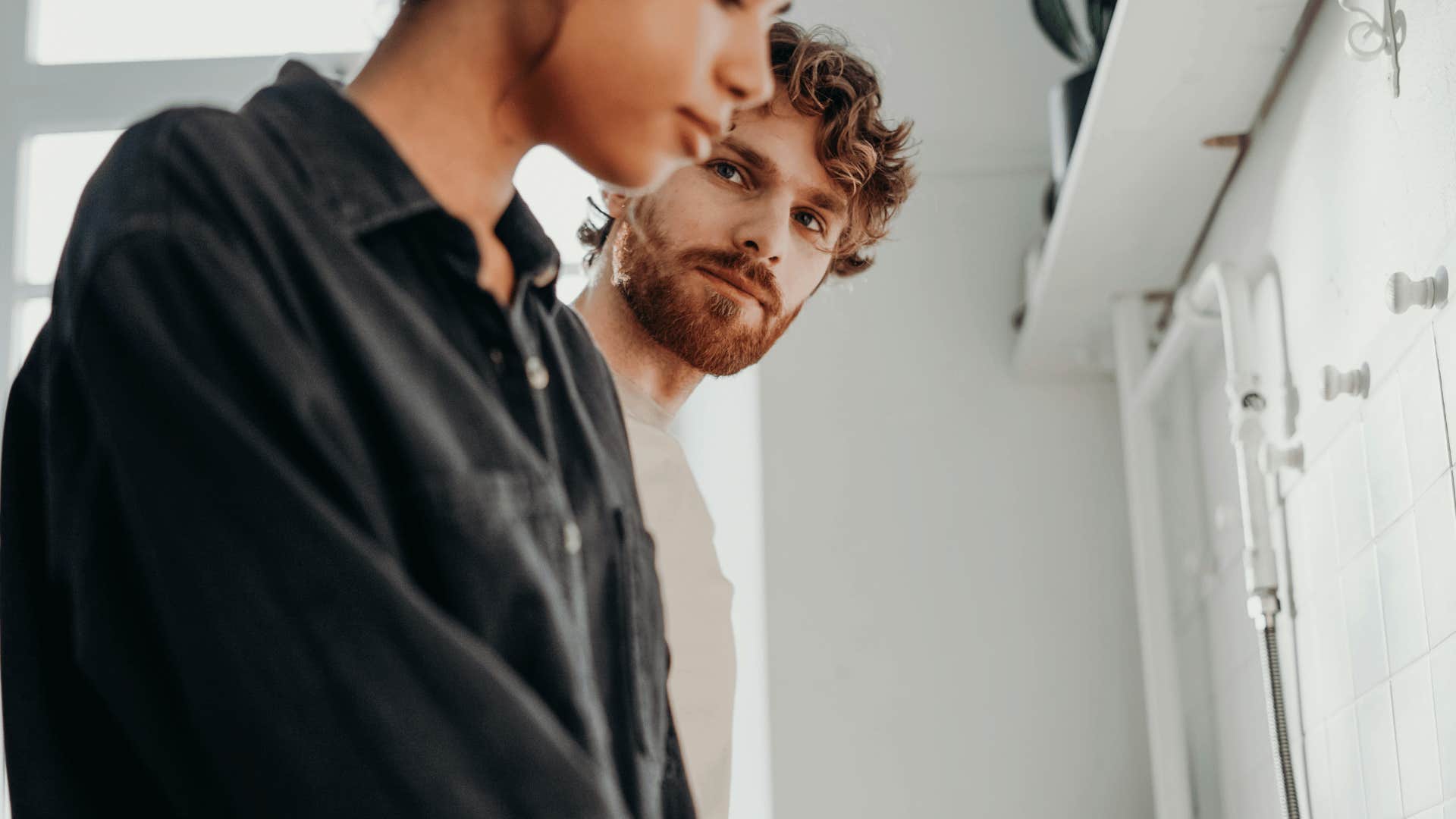 man staring at woman who is not meeting eye contact