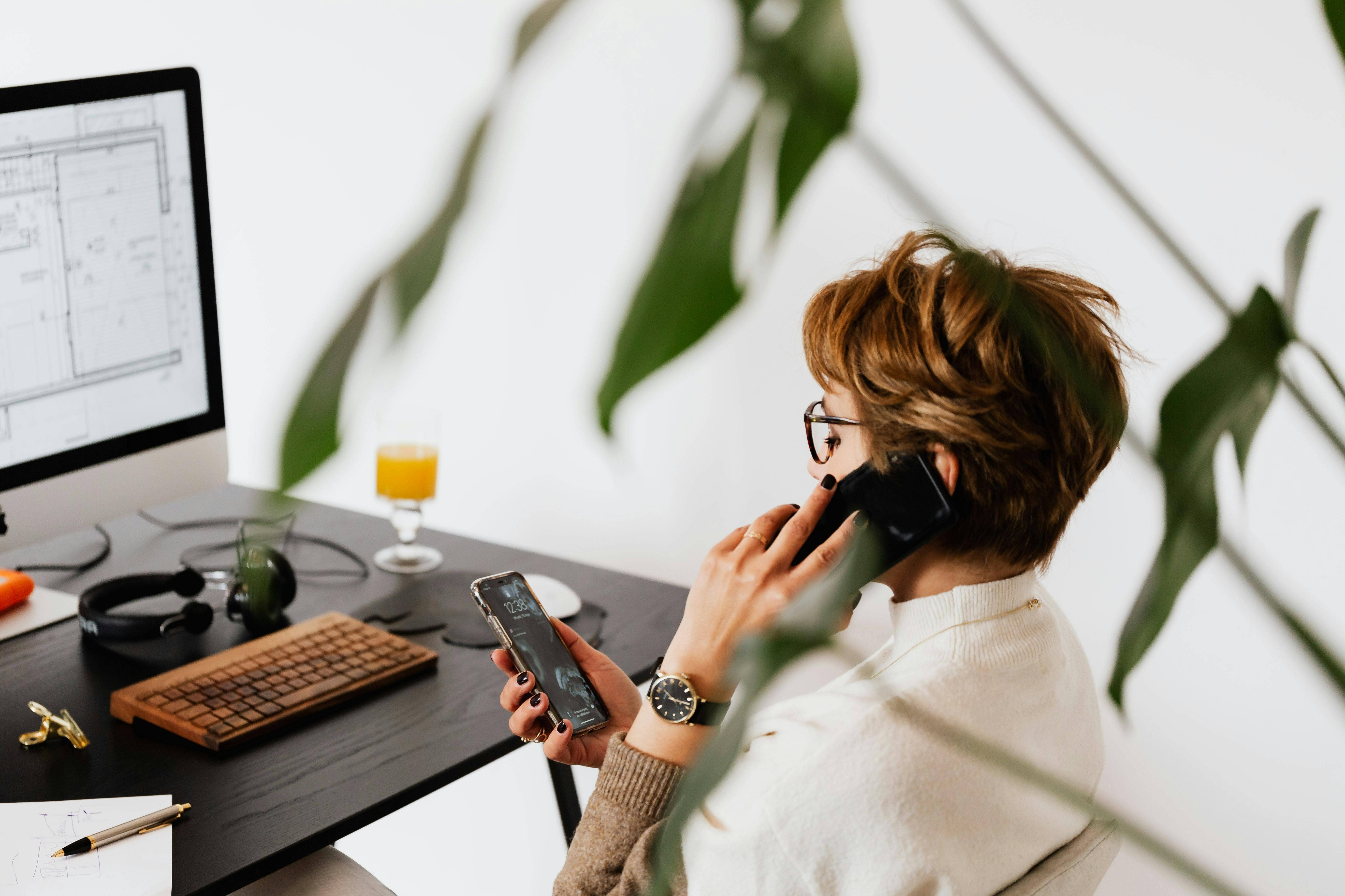 woman on work call checking her phone