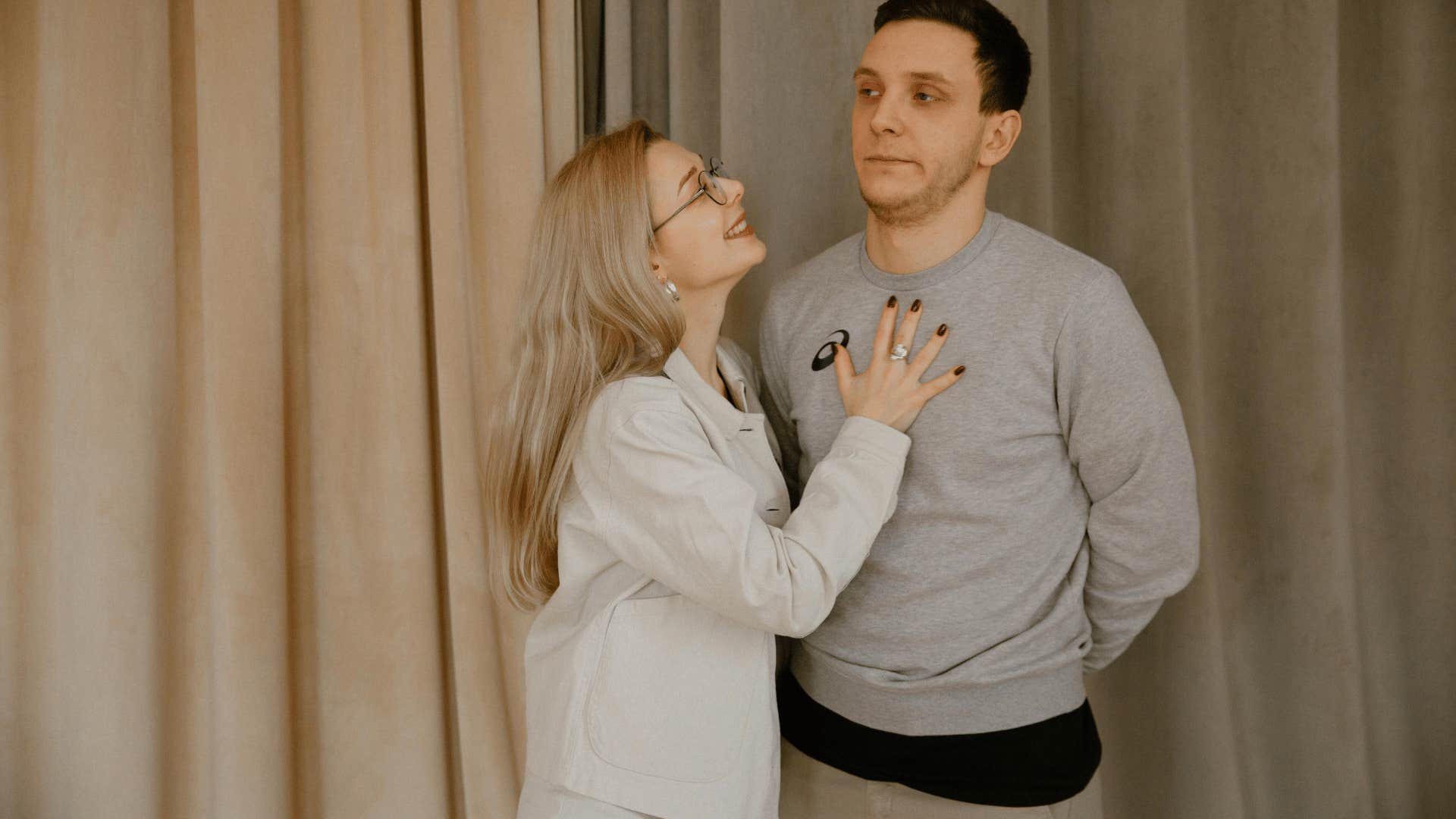 smiling woman hand on man's chest