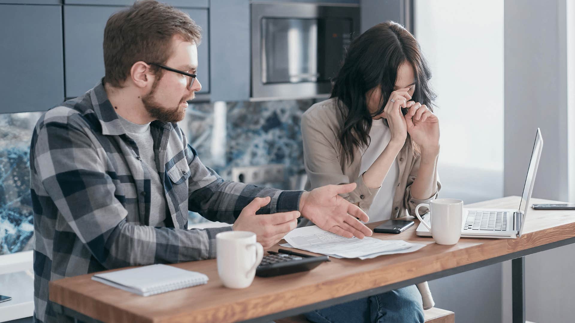 man criticizing upset woman