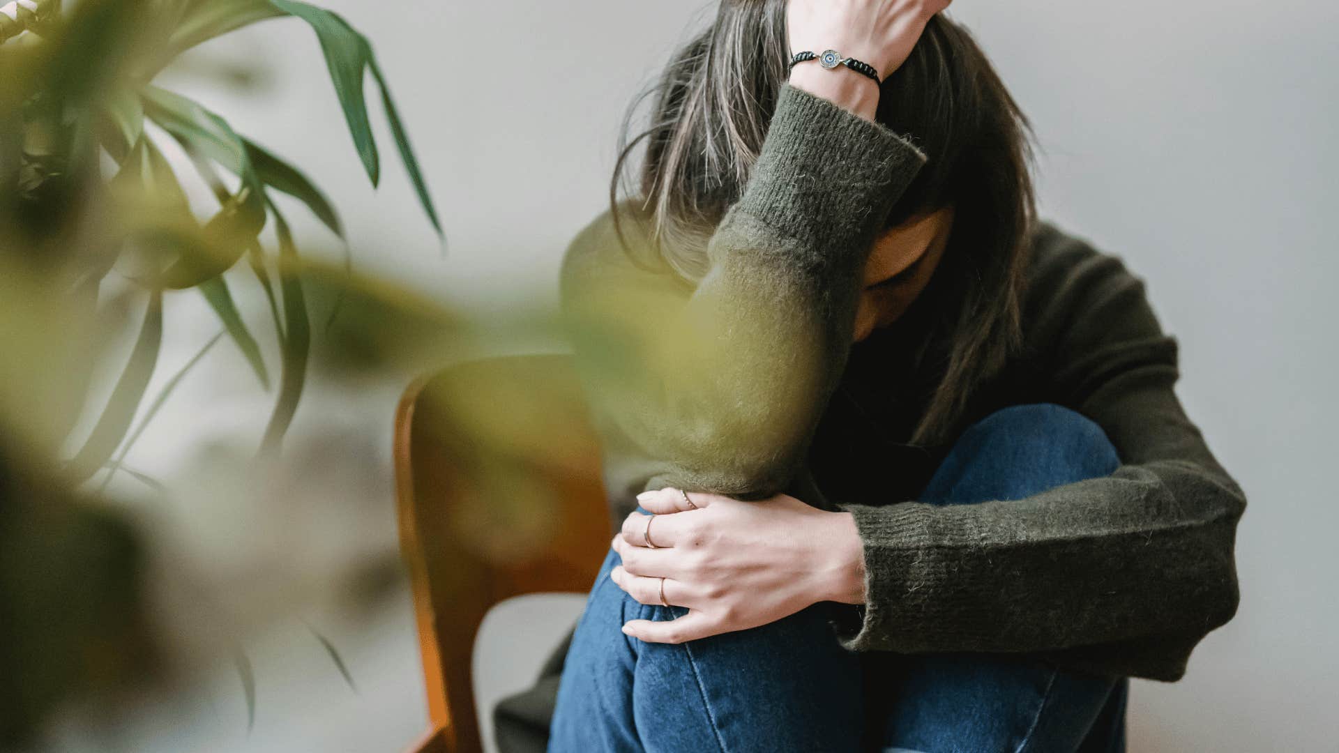 upset woman hugging her knees