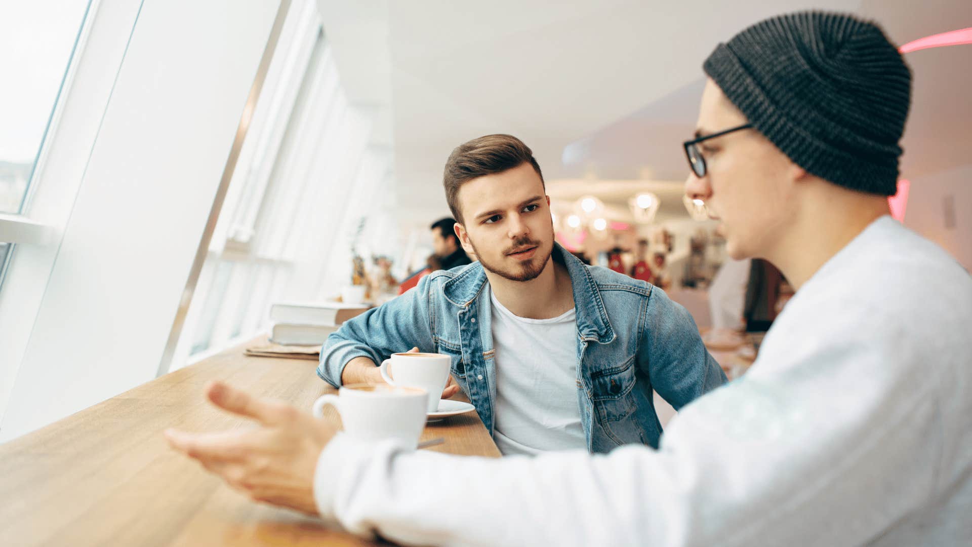 two men talking over coffee