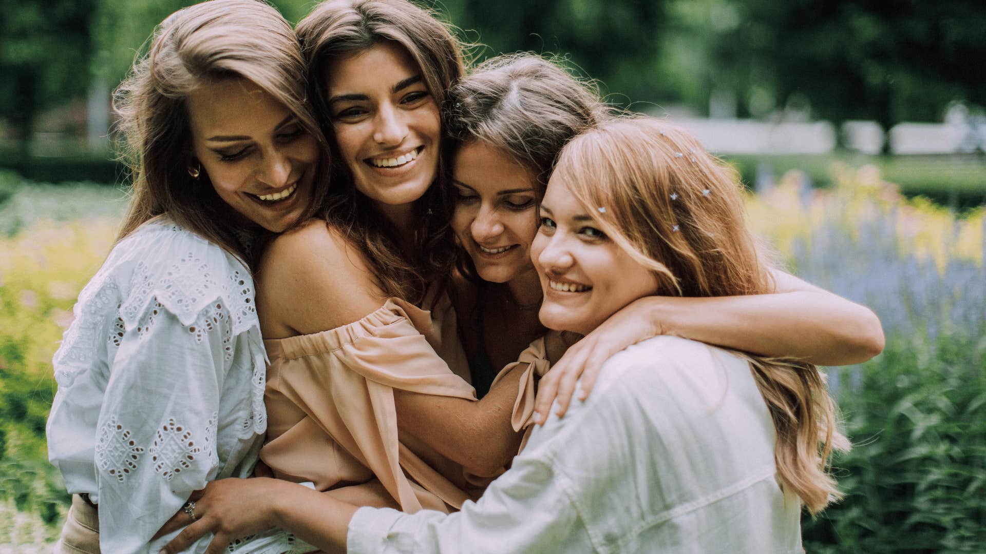 smiling and hugging group of friends