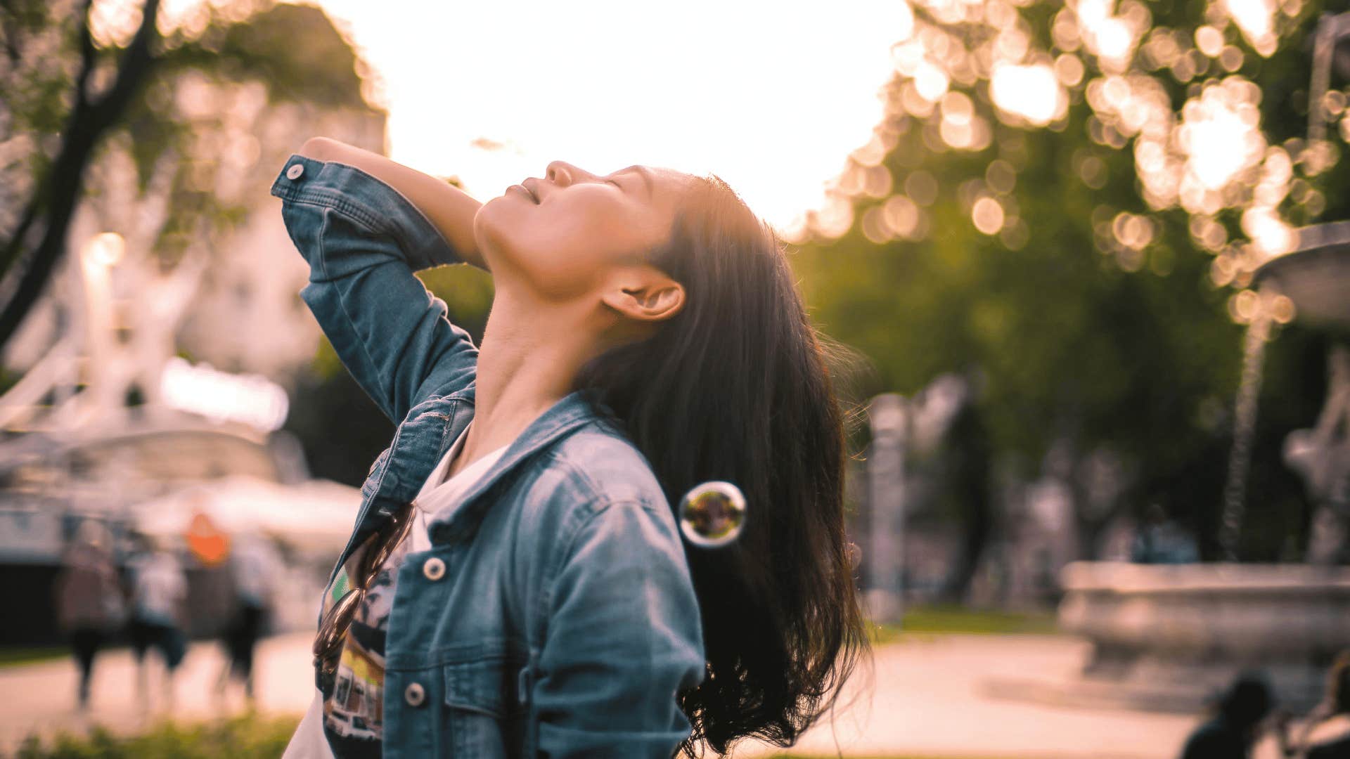 woman raising face to sky