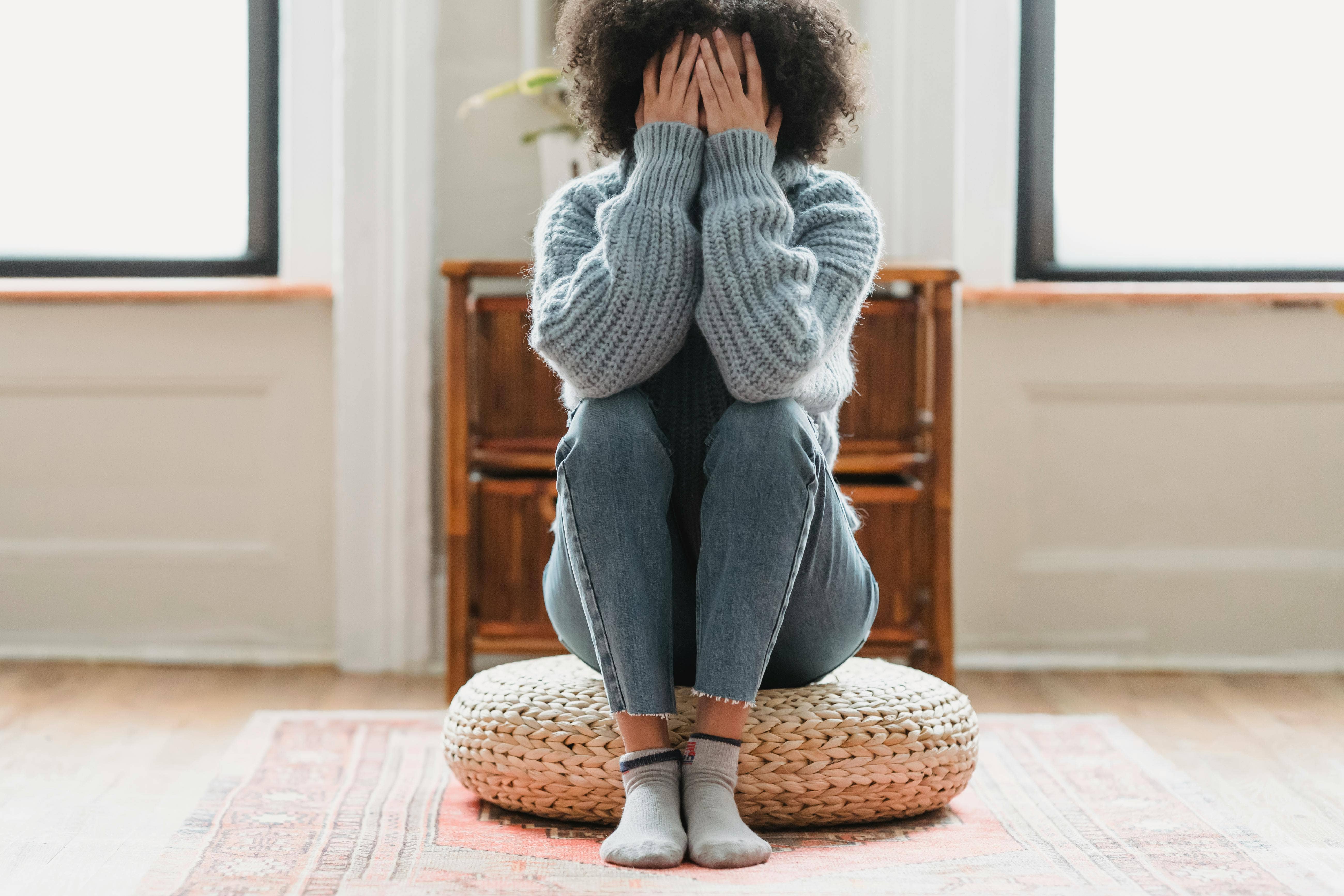 upset woman with her face in her hands