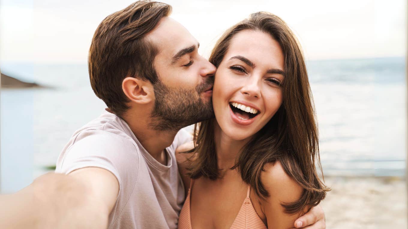 Man genuinely kissing woman's cheek