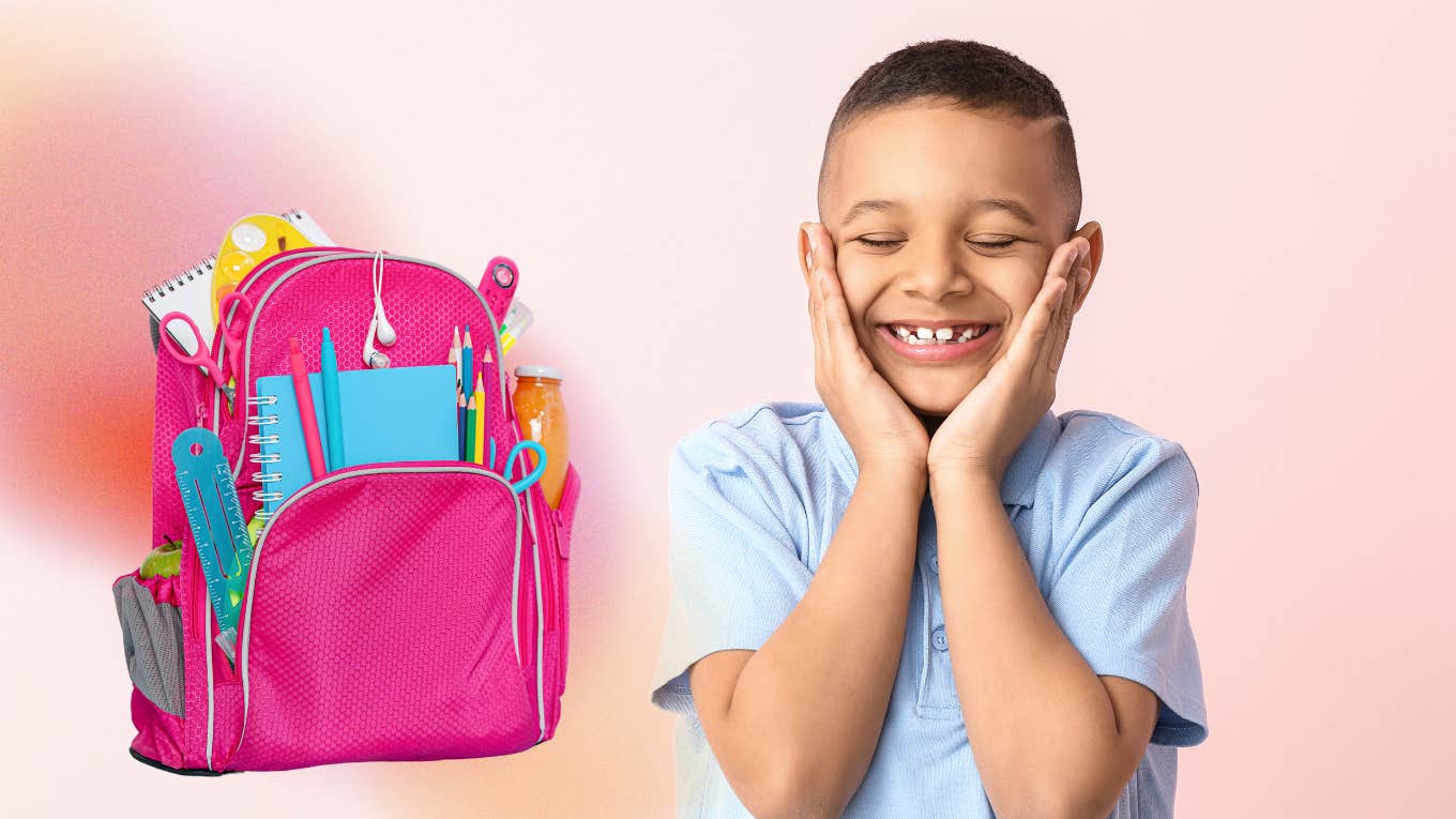 happy young boy and pink background beside pink backpack