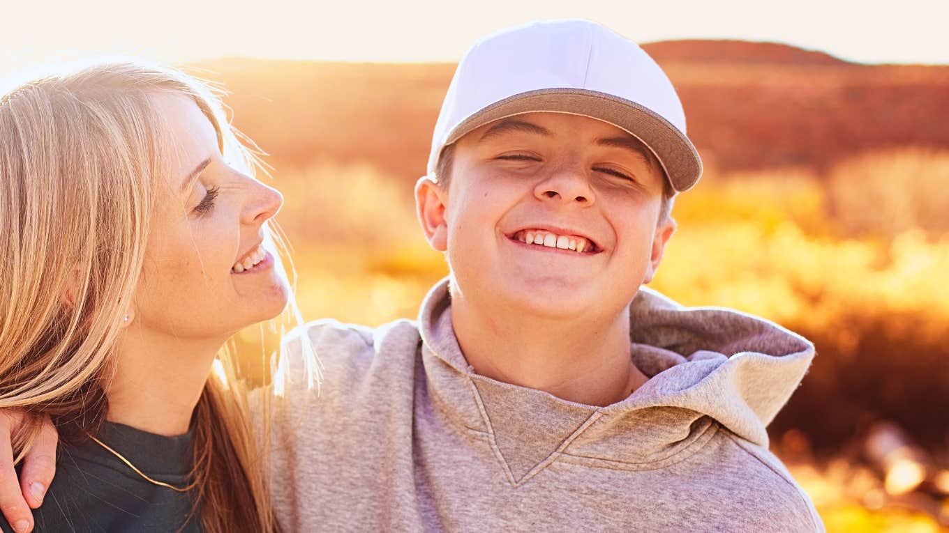 Mom smiling at teen son who may think she's being a hypocrite