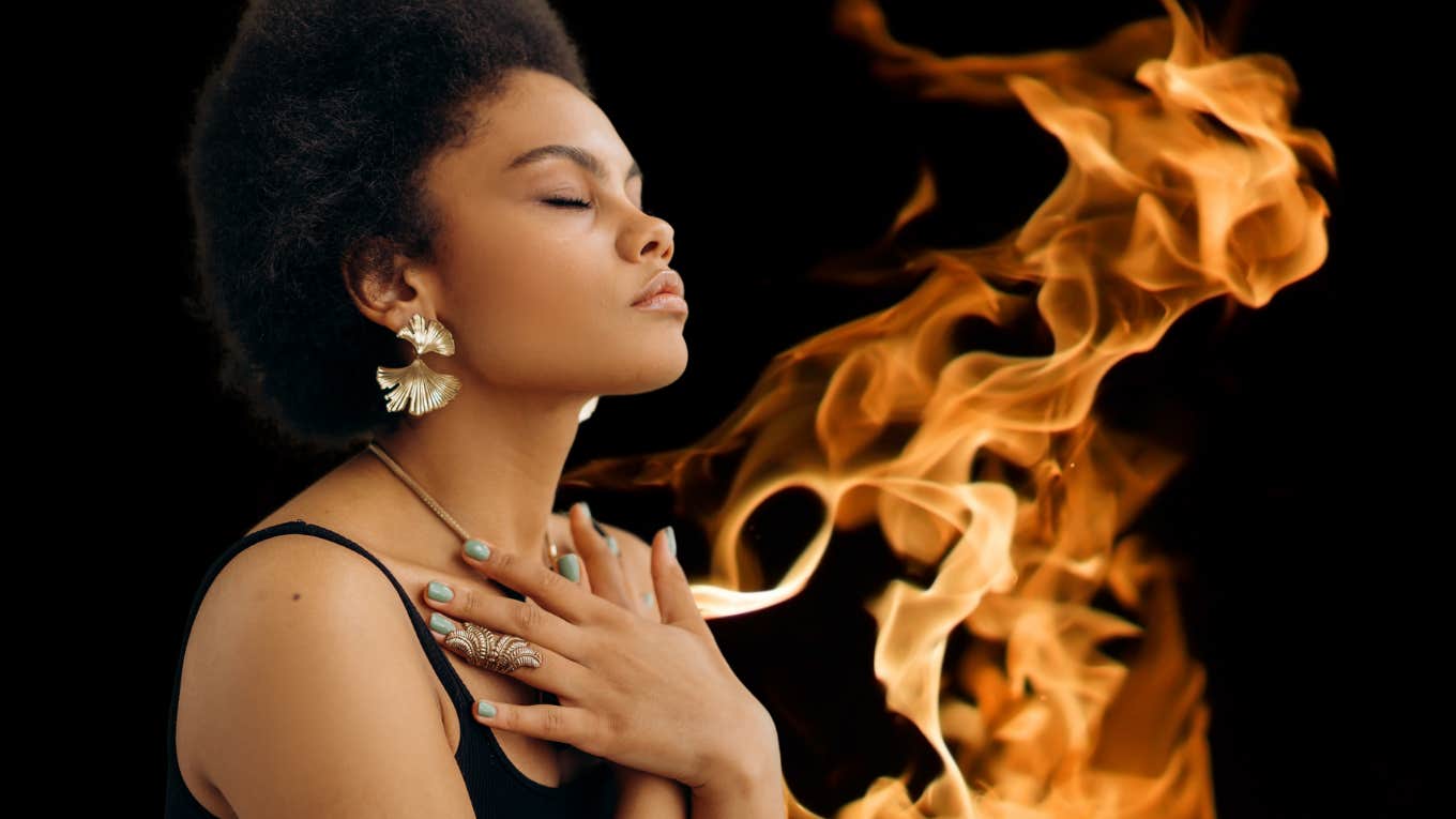 woman meditating with fiery background