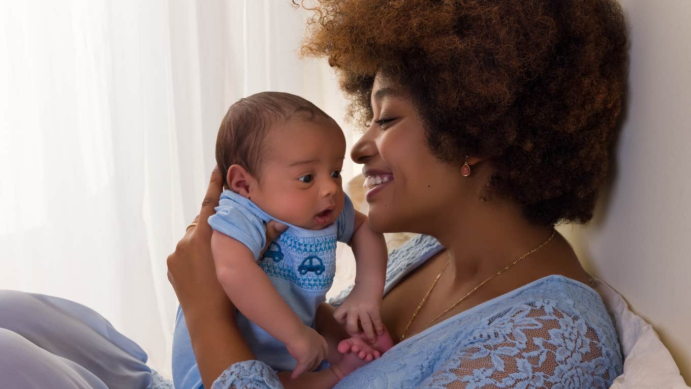 Adult woman holding her baby. 