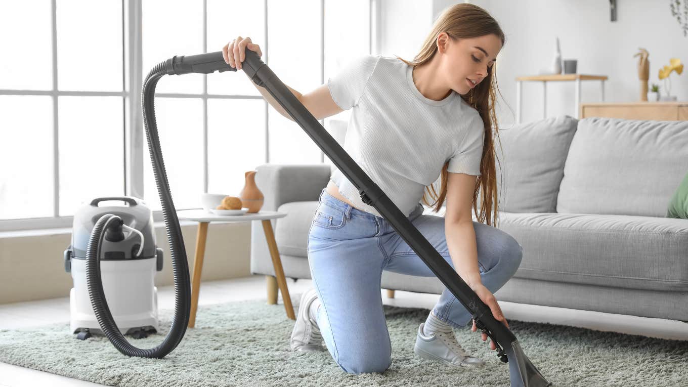 AirBnb host vacuuming the carpet of her home. 