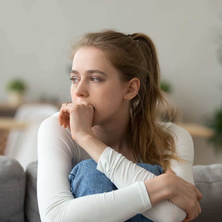 anxious woman making herself small to please others