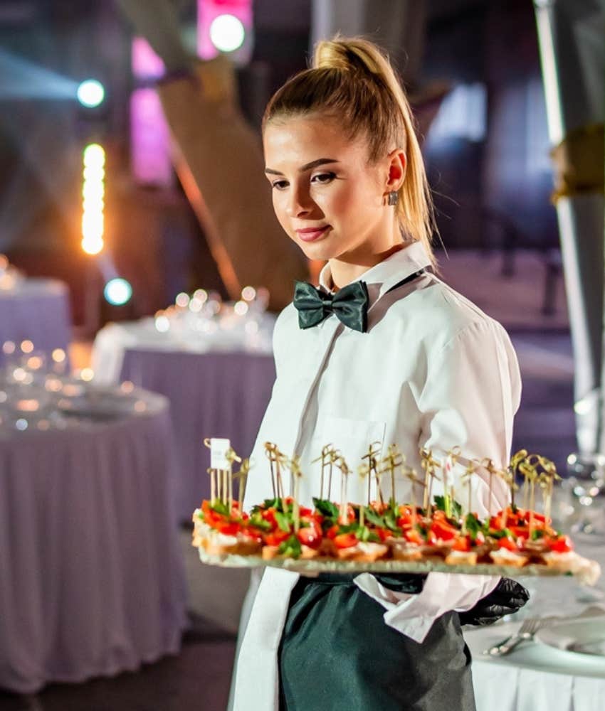 server holding tray of appetizers at wedding