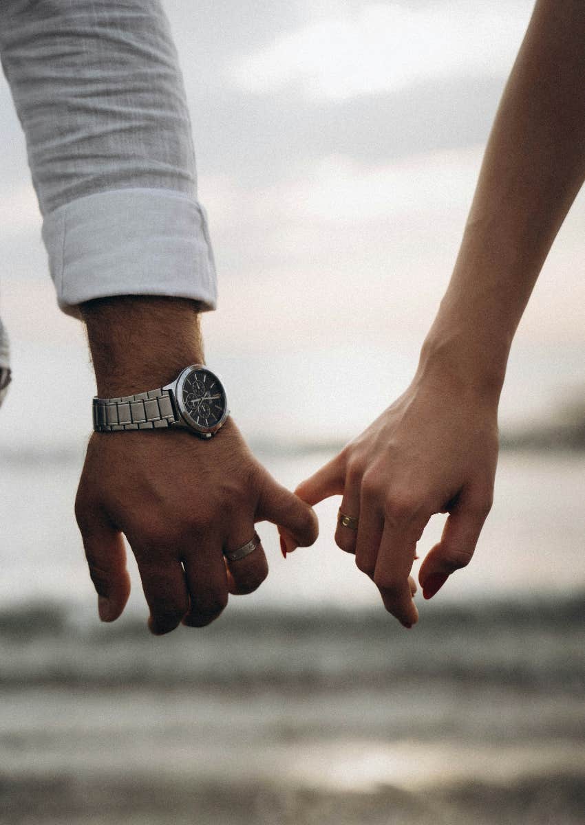 couple holding hands hoping relationship lasts 2024