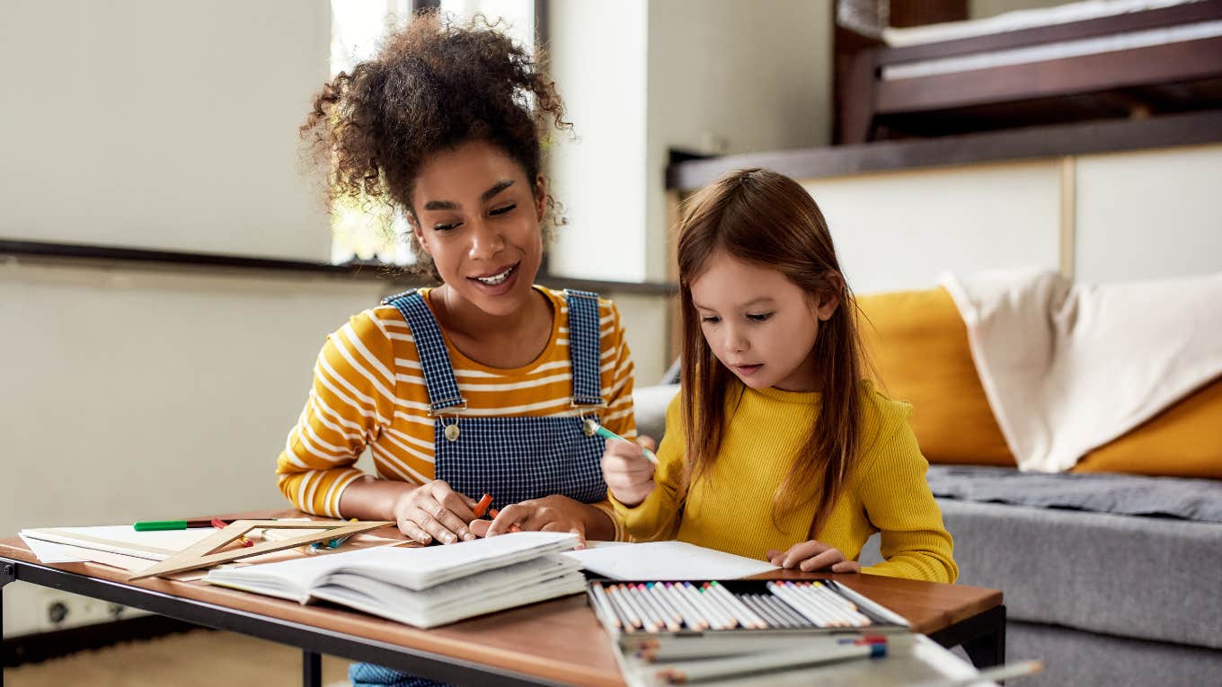 babysitter working on an art project with little girl