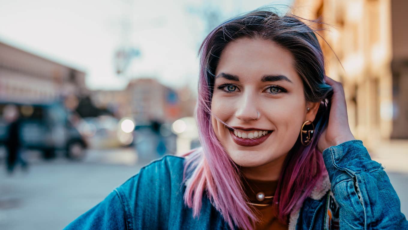 dignified and respectable woman with pink hair smiling