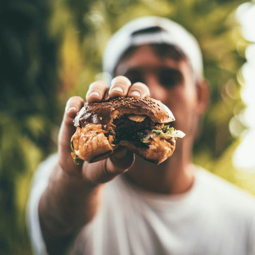 blurred person holding burger