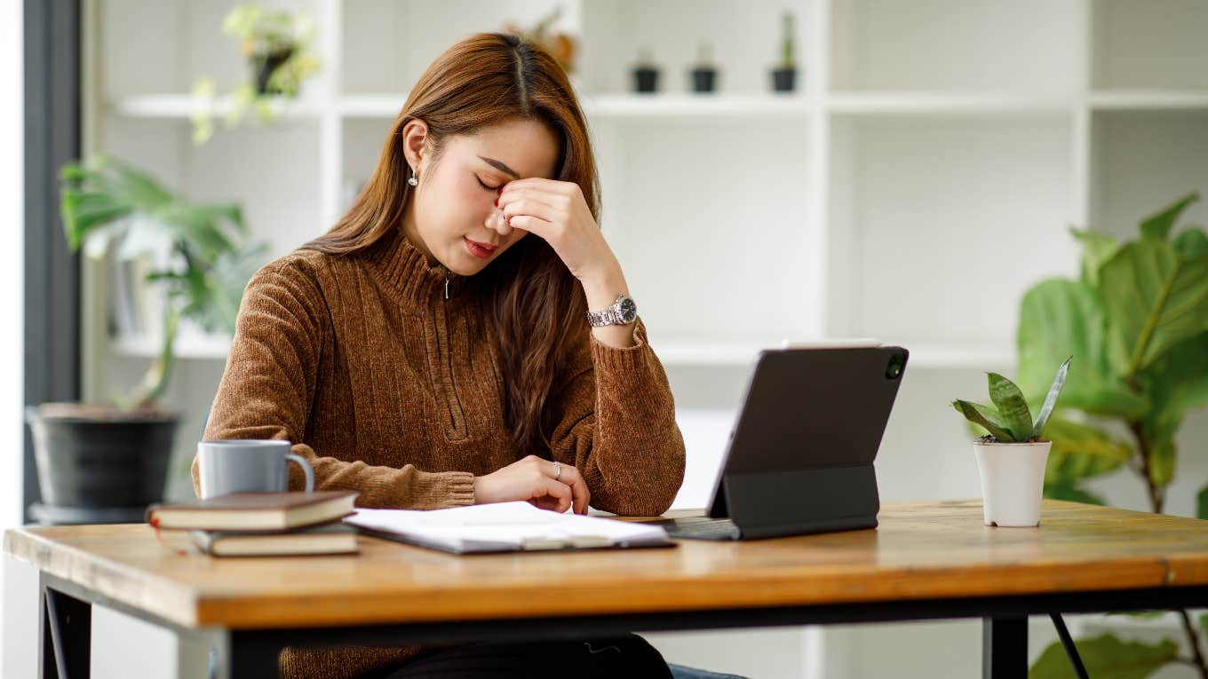 Burned out worker looking at fake job posting