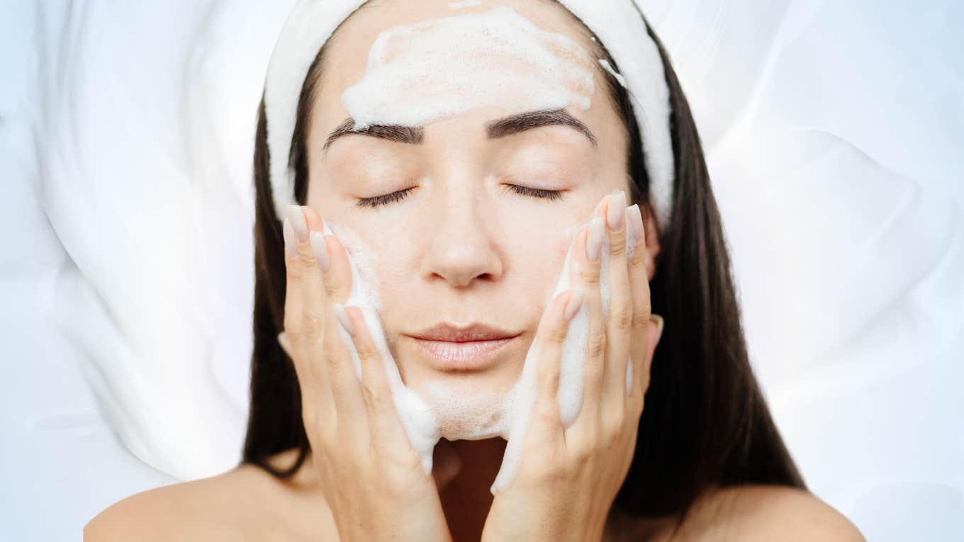 Woman cleanses her skin as she cleanse her toxic ex from her life and feels refreshed.