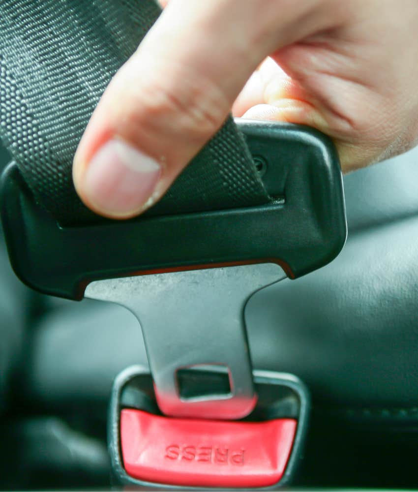 hand clicking car seatbelt