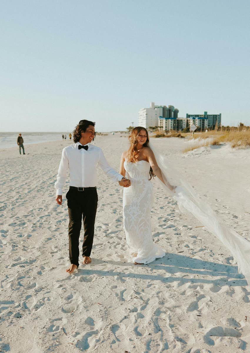 bride and groom walking on the beach