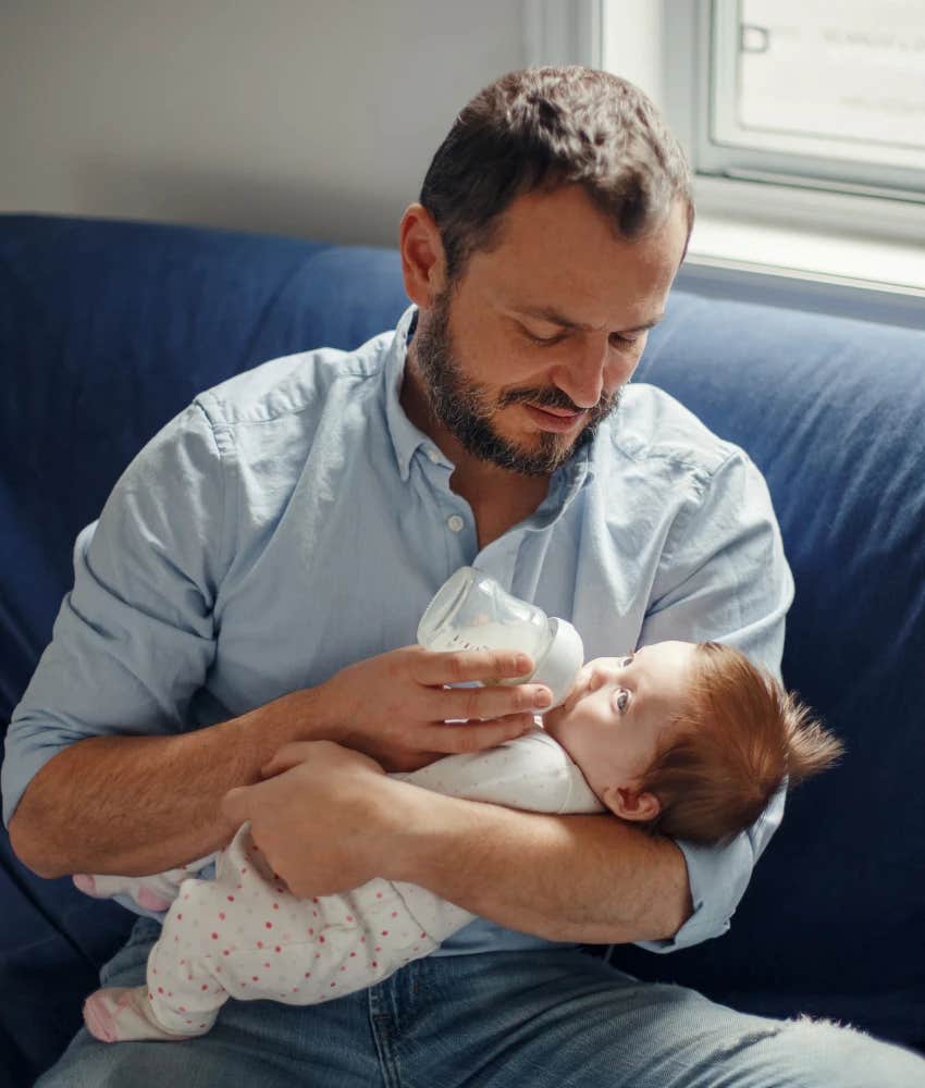 Dad on paternity leave feeding baby