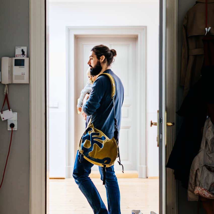 dad carrying kid leaving house with packed duffel bag