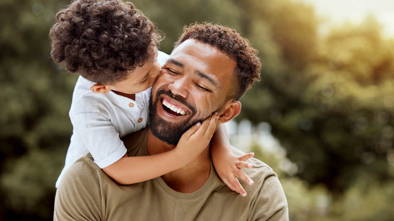 son kissing father on cheek