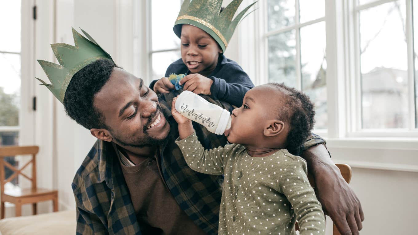 dad playing with kids wearing crowns