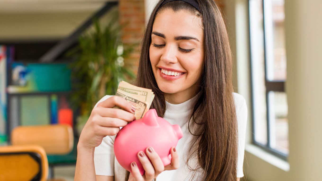 frugal woman putting money away