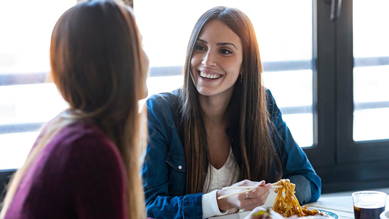 Two female friends talking over dinner