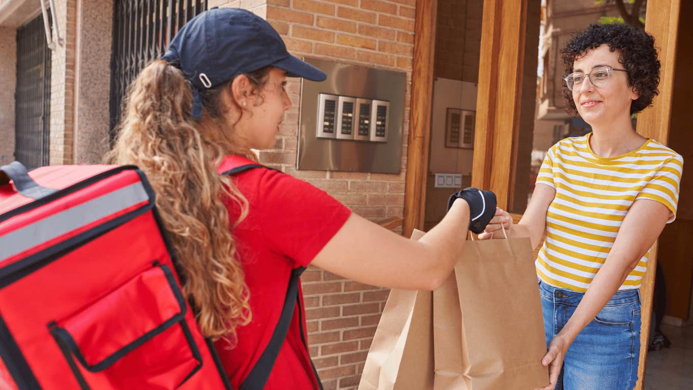 woman delivering food to another woman 