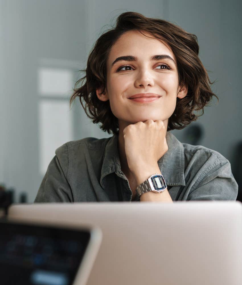 Female employee smiling and feeling happy at work