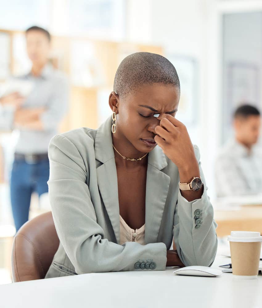 Female employee with hand on her head feeling stressed out