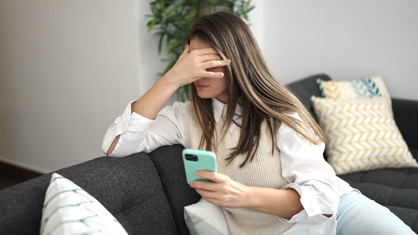 Employee on her phone feeling uneasy about her bosses following her on social media