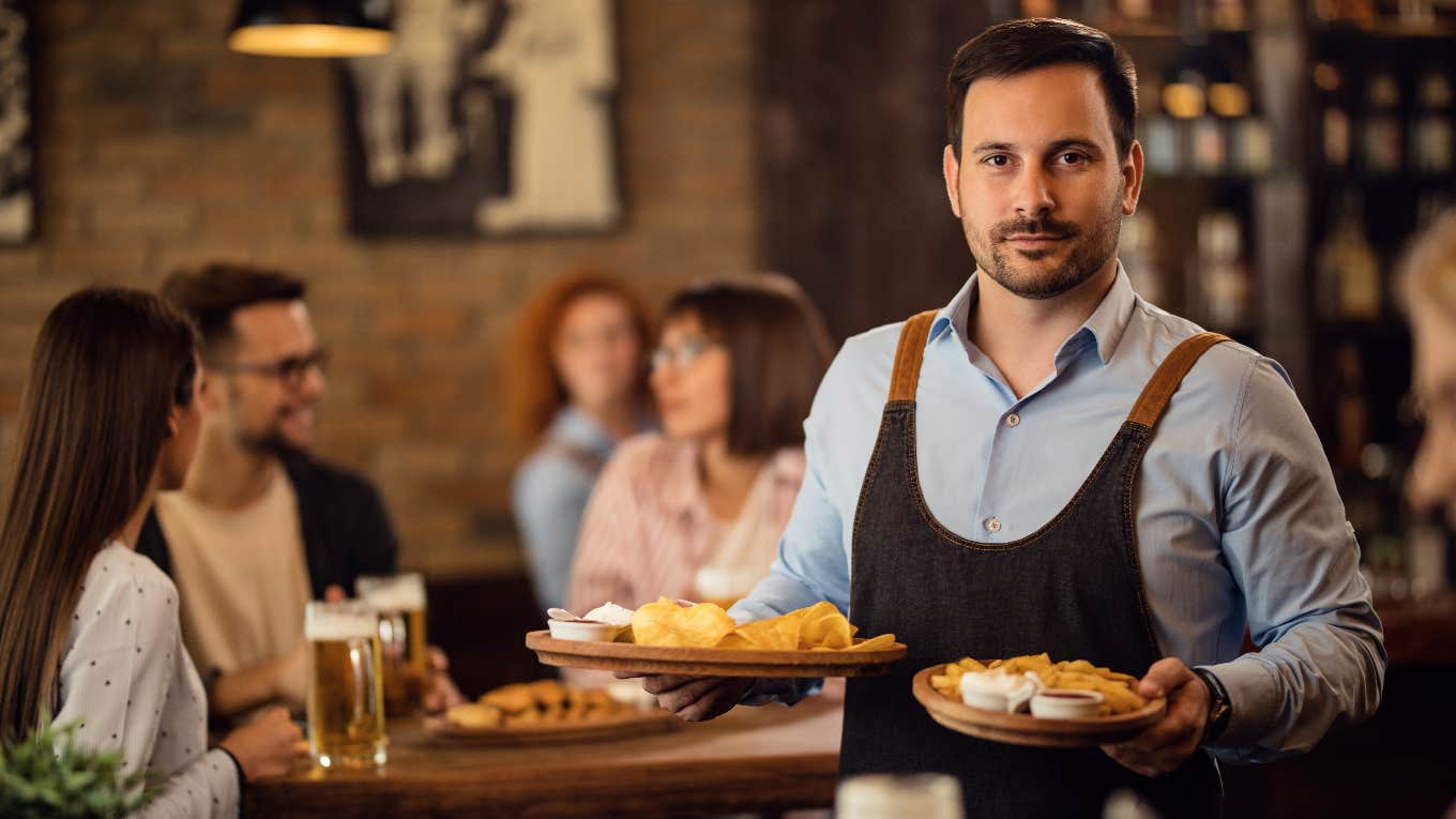 Demanding customer demands that waiter stop kissing couple sitting next to her