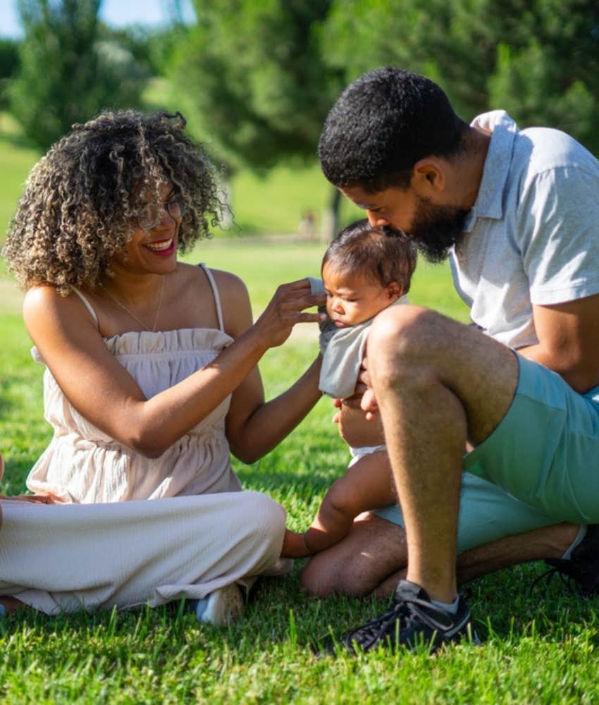 parents with baby in the park