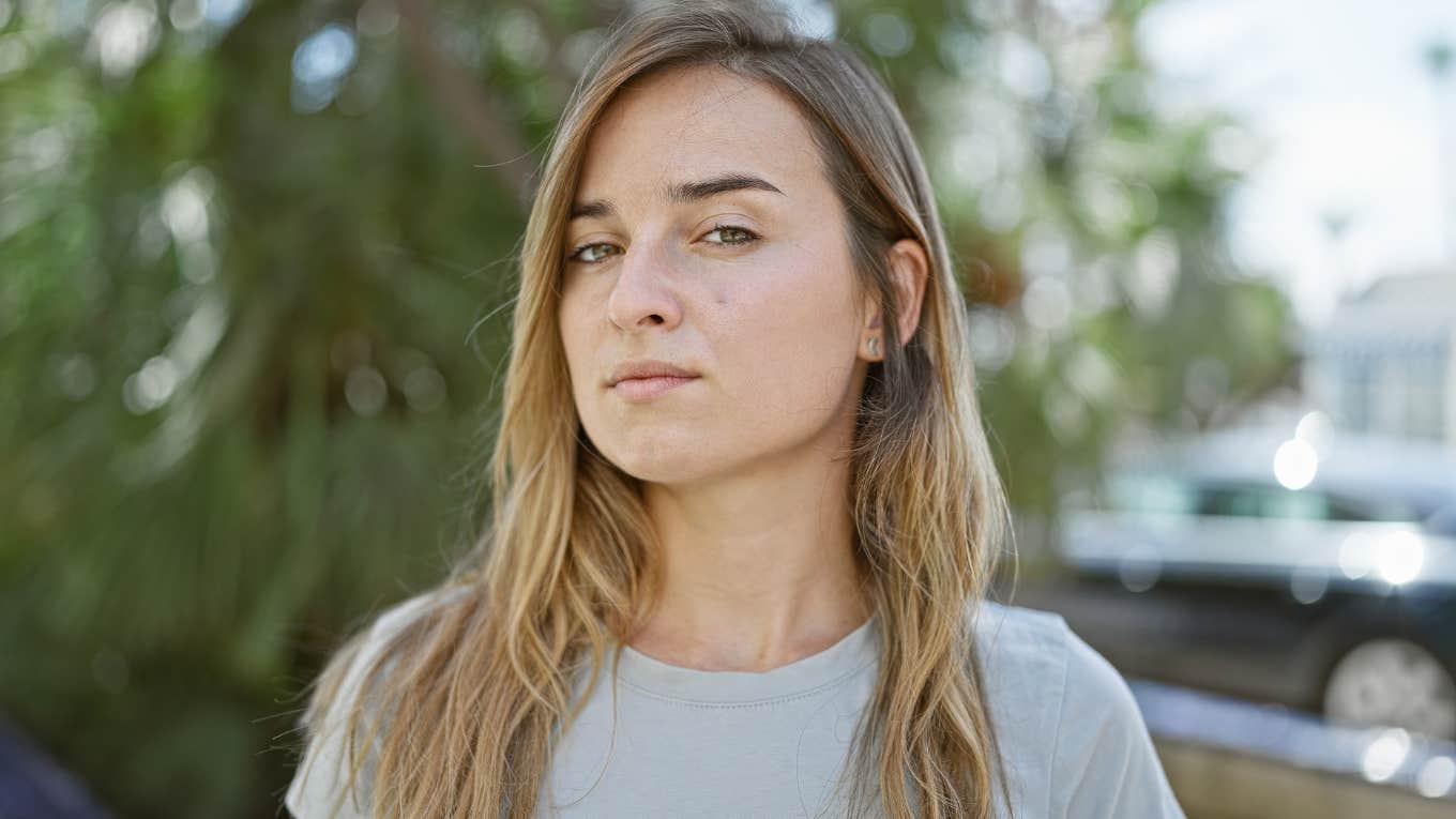 Woman looking solemn staring at the camera.