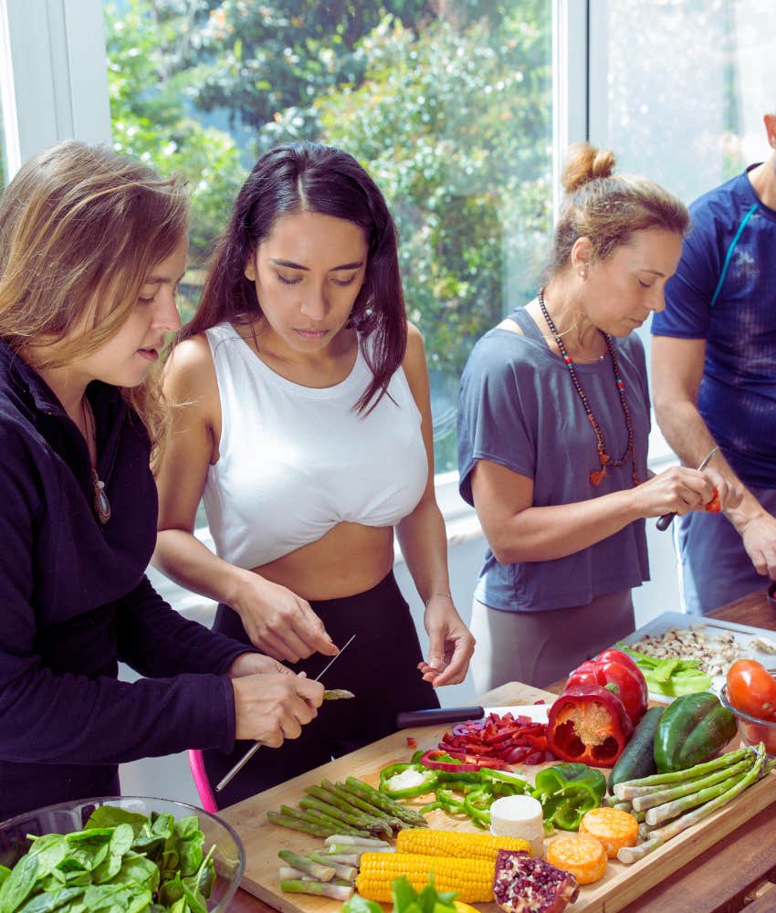 group of people preparing large tray of food