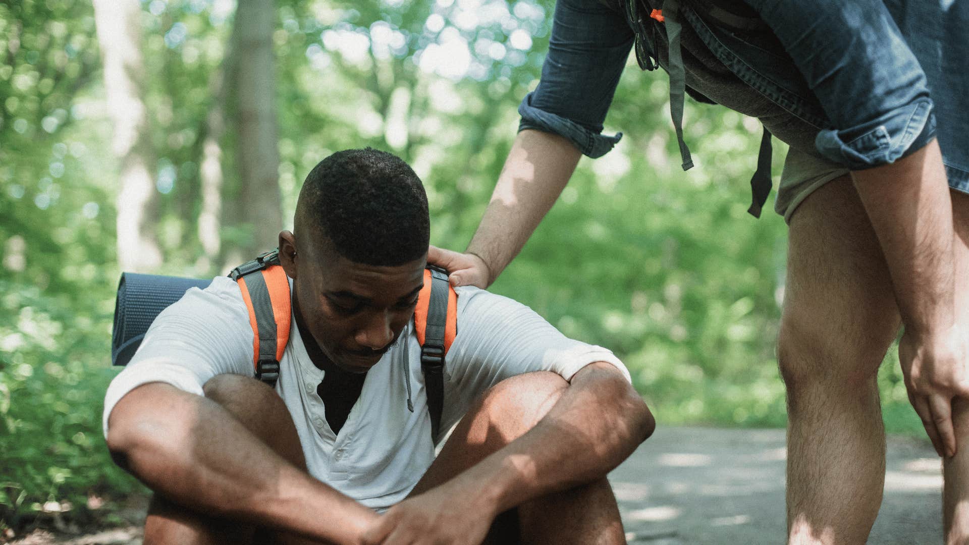 guy comforting friend while hiking