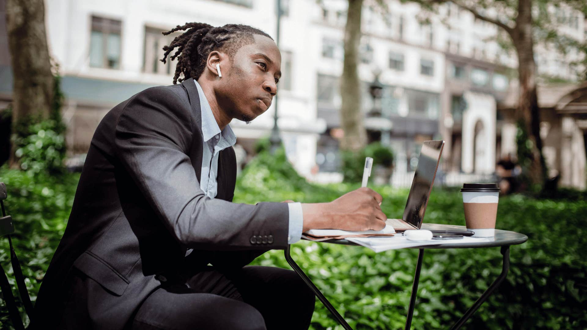 man writing on paper