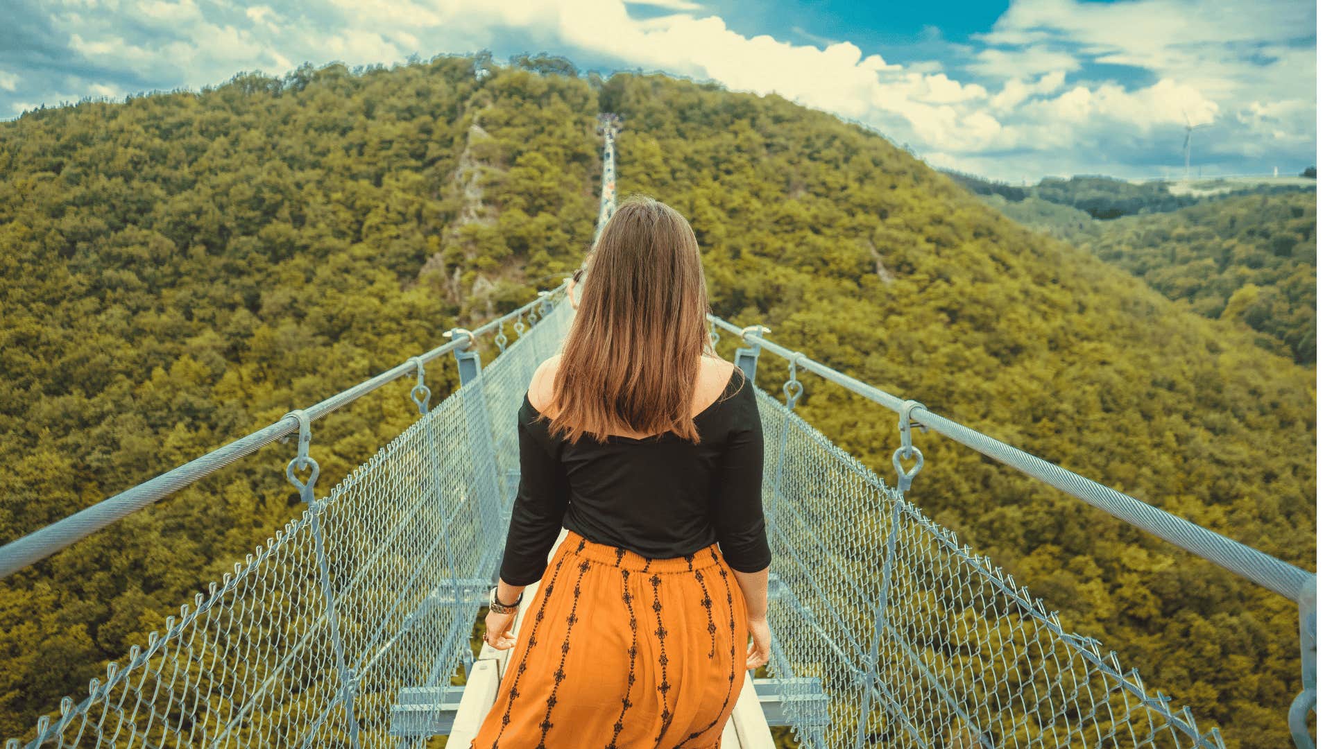 adventurous woman crossing a bridge