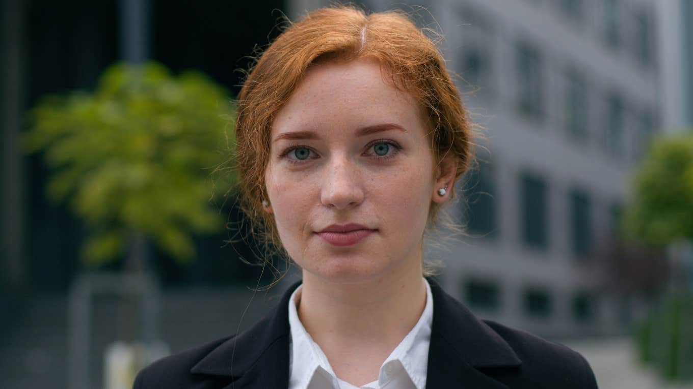 redheaded woman looking serious thinking about life lessons